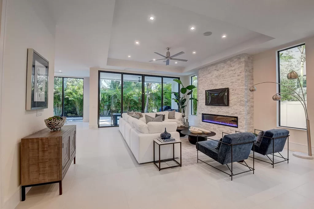 Modern living room with clean lines, neutral tones, and access to an outdoor area.